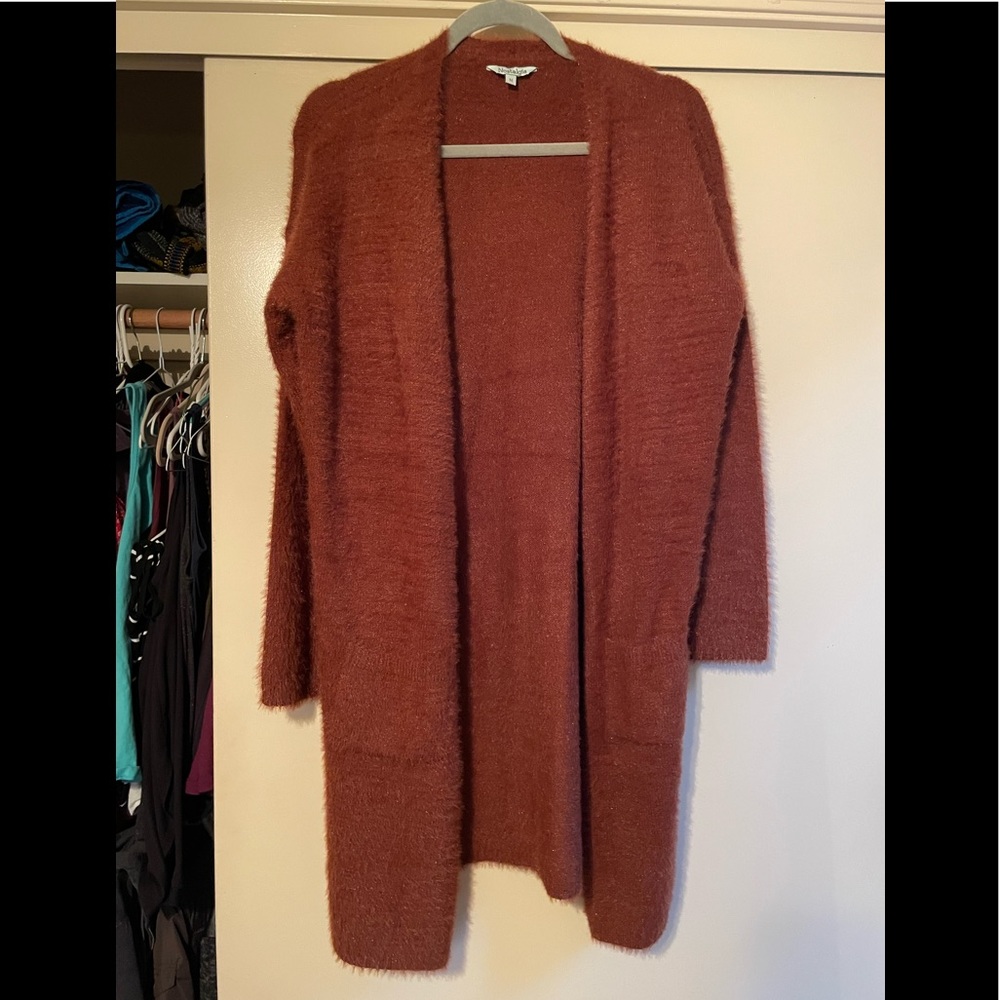 Fuzzy brown/rust orange long pullover with pockets.